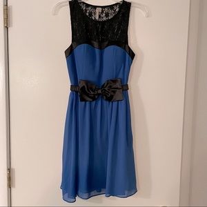 Royal blue dress with black lace detail and bow